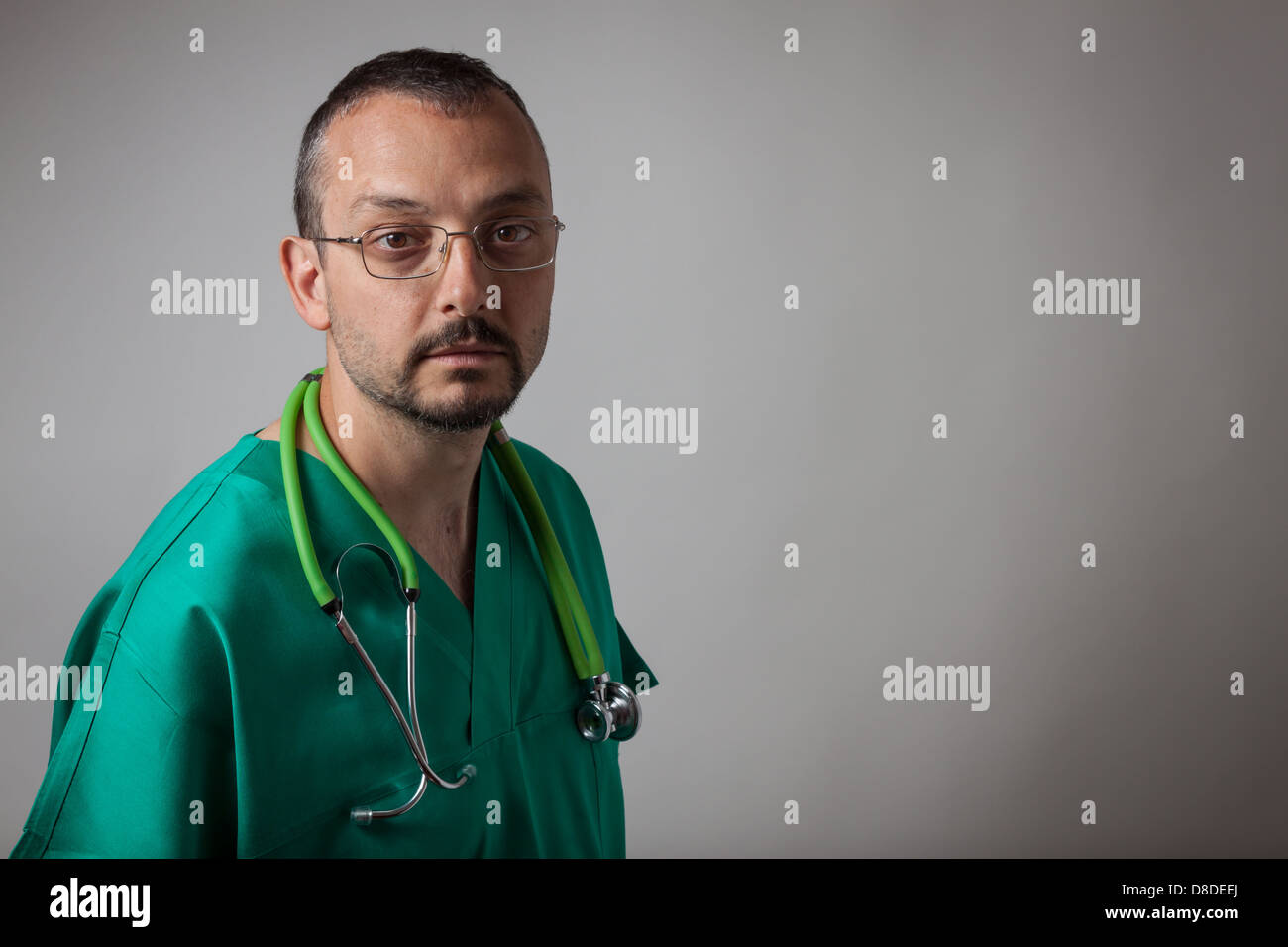 Portrait of a young physician with green uniform Stock Photo