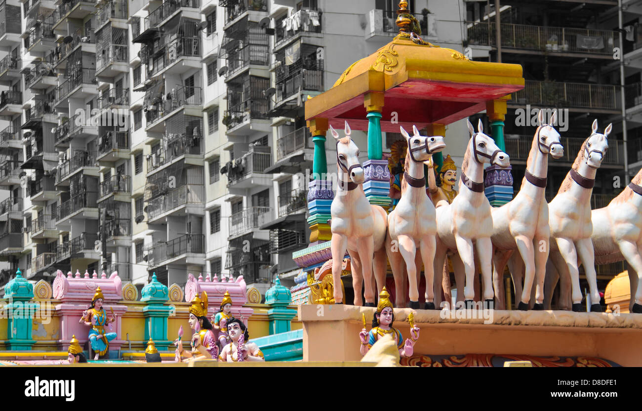 Hindu temple sculptures in front a low cost apartment housing area