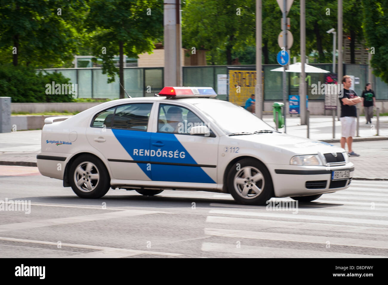 Hungary Budapest moving white blue police cop car Rendorseg on road street scene Stock Photo