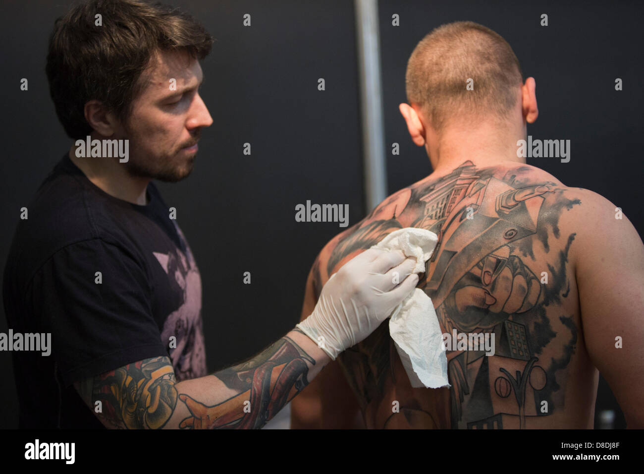 London, UK. 26th May, 2013. Picture: Tattoo artists at work. The Great British Tattoo Show takes place at Alexandra Palace in London, UK. Photo: Nick Savage/Alamy Live News Stock Photo