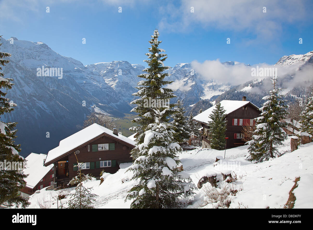 Winter holiday houses in swiss alps Stock Photo - Alamy