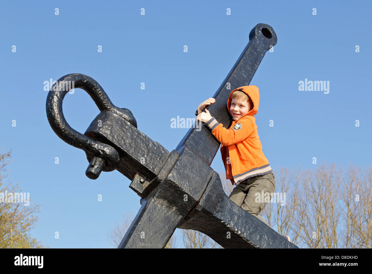 young boy climbing an anchor, Privall, Travemuende, Schleswig-Holstein, Germany Stock Photo