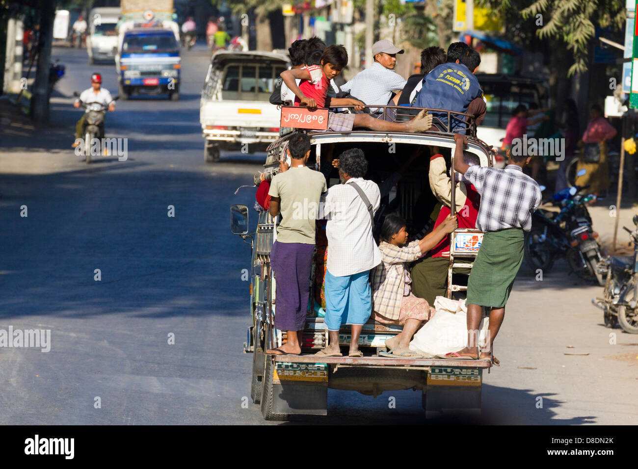Chaotic road traffic on Mandalay roads, Myanmar 4 - overloaded public transport pickup Stock Photo