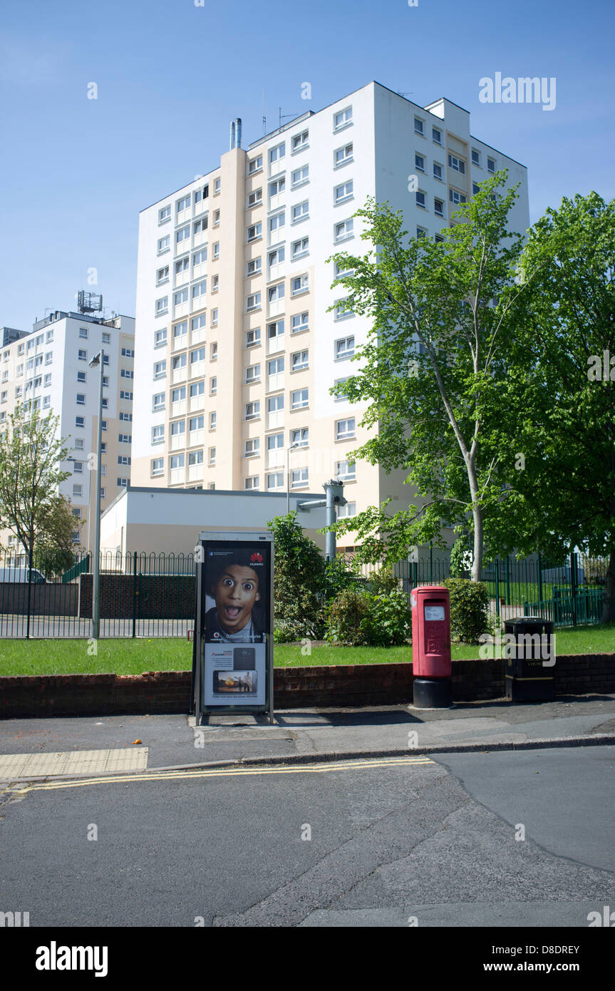 A block of residential flats, with a telephone box and postbox in the foreground Stock Photo