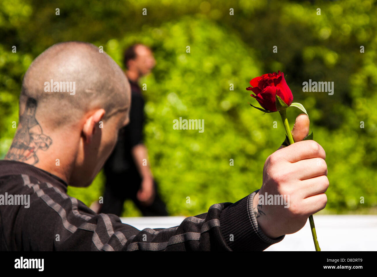 Woolwich, London, UK. 26th May, 2013. With his single red rose, a man  marches with the English Defence League and their supporters through Woolwich to pay respects to murdered soldier, DrummER Lee Rigby. Credit: Paul Davey/Alamy Live News Stock Photo