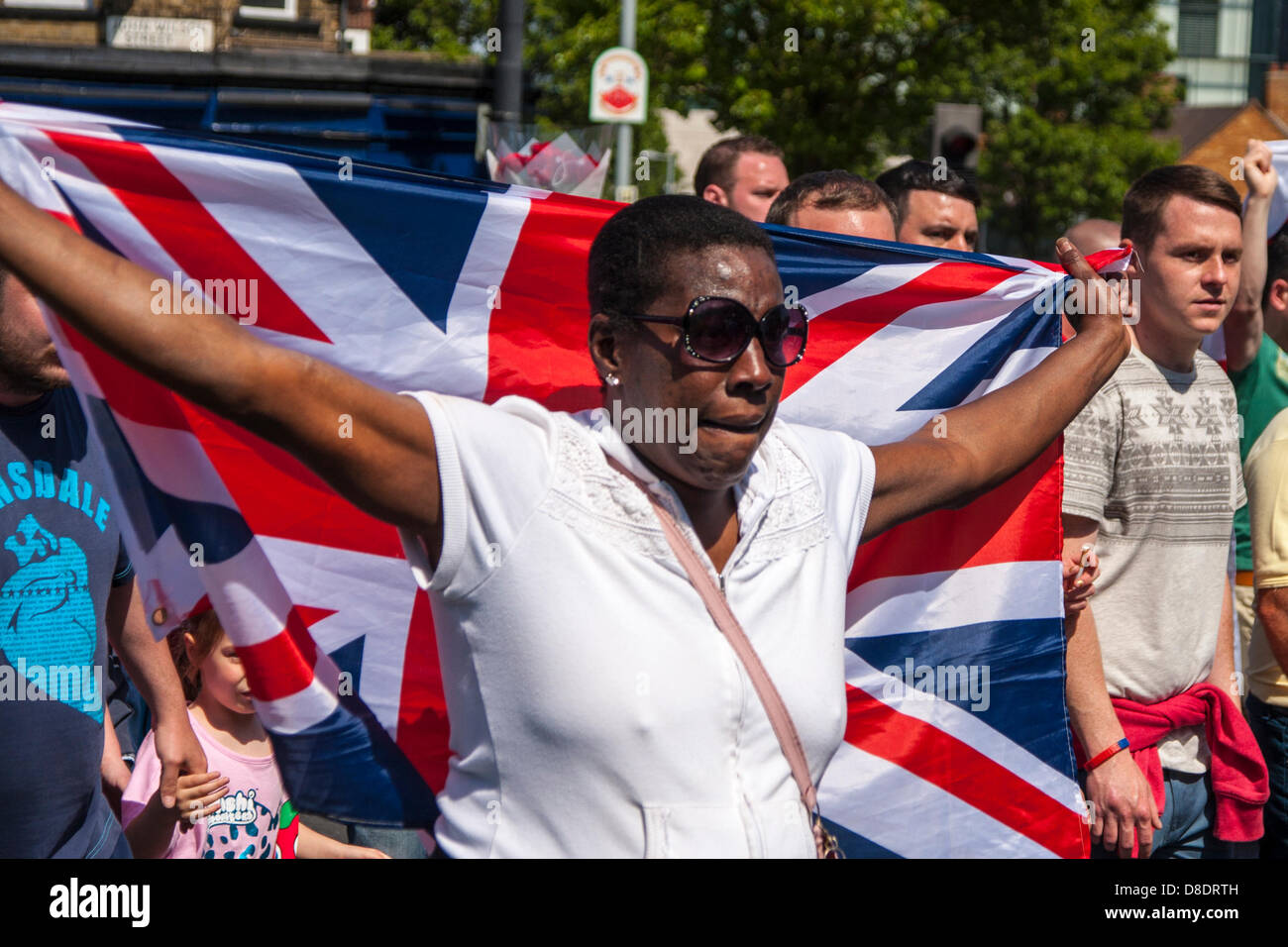 Woolwich, London, UK. 26th May, 2013. A black woman marches with the English Defence League and their supporters as they head towards the site of Drummer Lee Rigby's muder to pay their respects. Credit: Paul Davey/Alamy Live News Stock Photo
