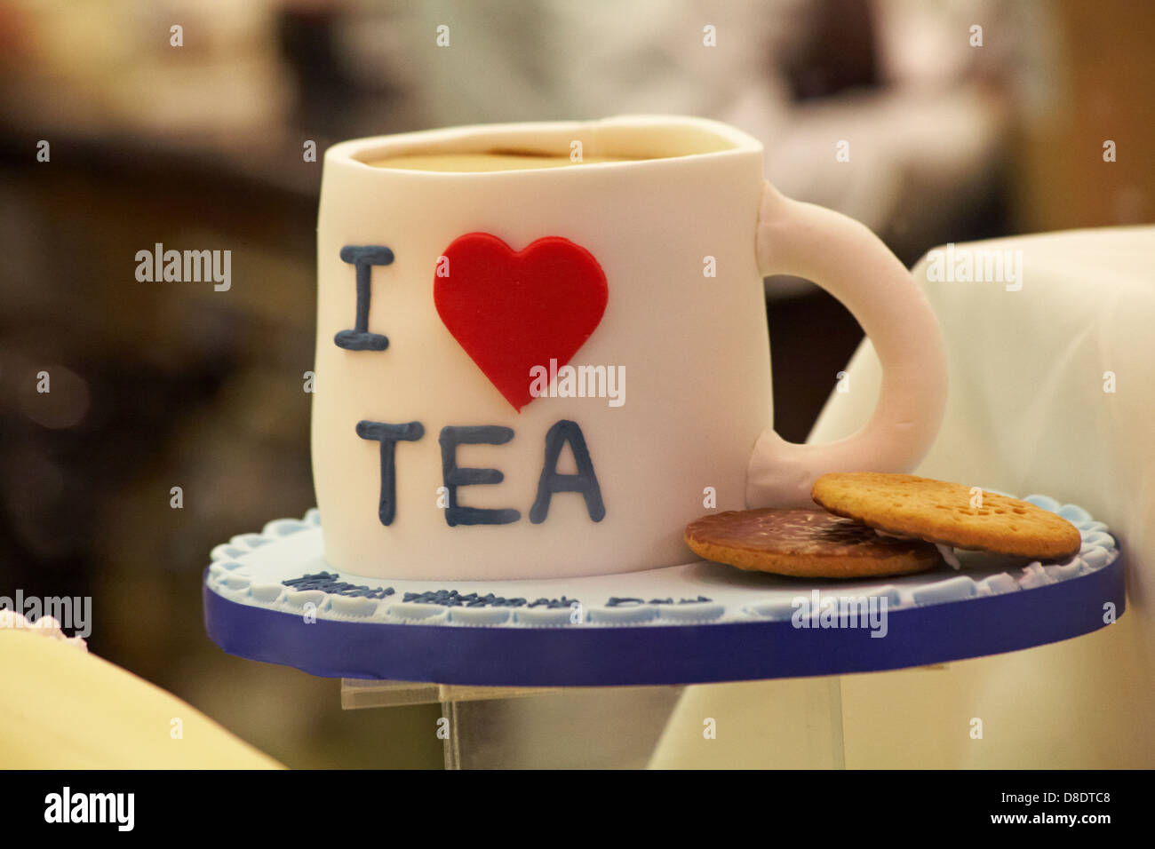 Iced cake in mug of tea I love tea and chocolate biscuits in the Cake Shop  at Oxford, Oxfordshire UK in May Stock Photo - Alamy