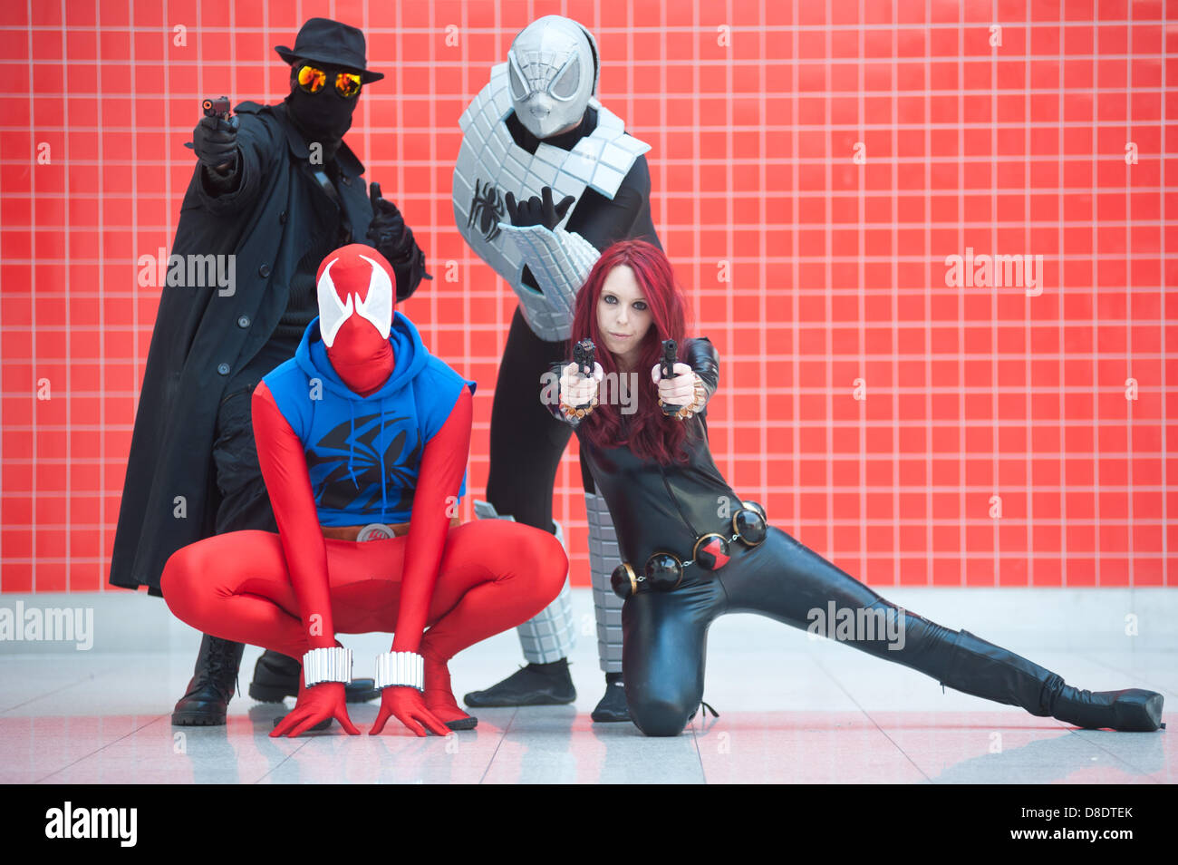London, UK - 26 May 2013: dorian Hawkins as Spiderman Noir, Chris Brown as Scarlett Spiderman, Garith Hawkins as Armed Spiderman and Rocy Kinnin as Black Widow pose for a picture during the London Comic Con 2013 at Excel London. London Comic Con is the UK's largest event dedicated to pop culture attracting thousands of artists, celebrities and fans of comic books, animes and movie memorabilia. Credit: Piero Cruciatti/Alamy Live News Stock Photo