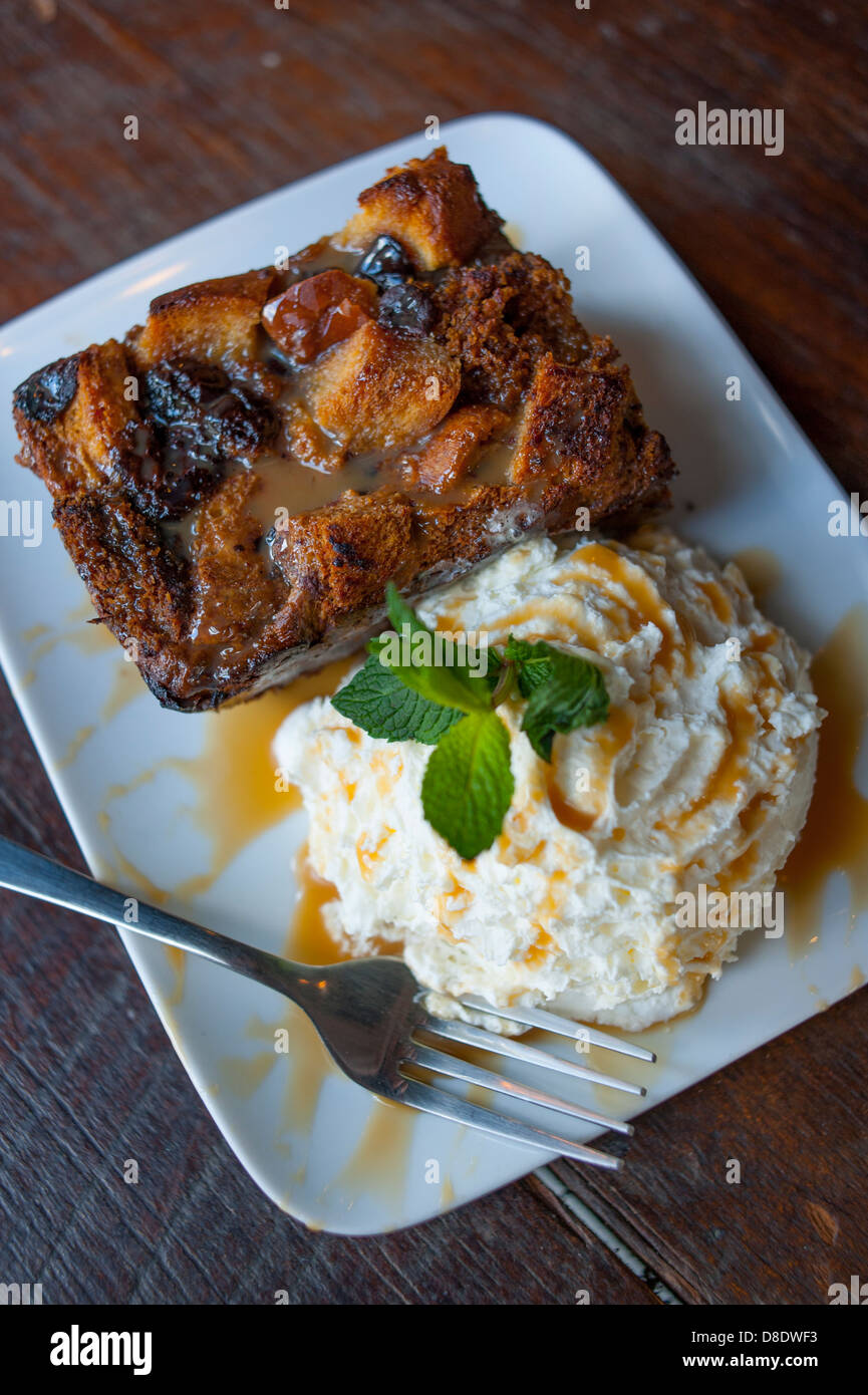 Food bread pudding and whipped cream at Please and Thank You in Louisville KY Stock Photo Alamy