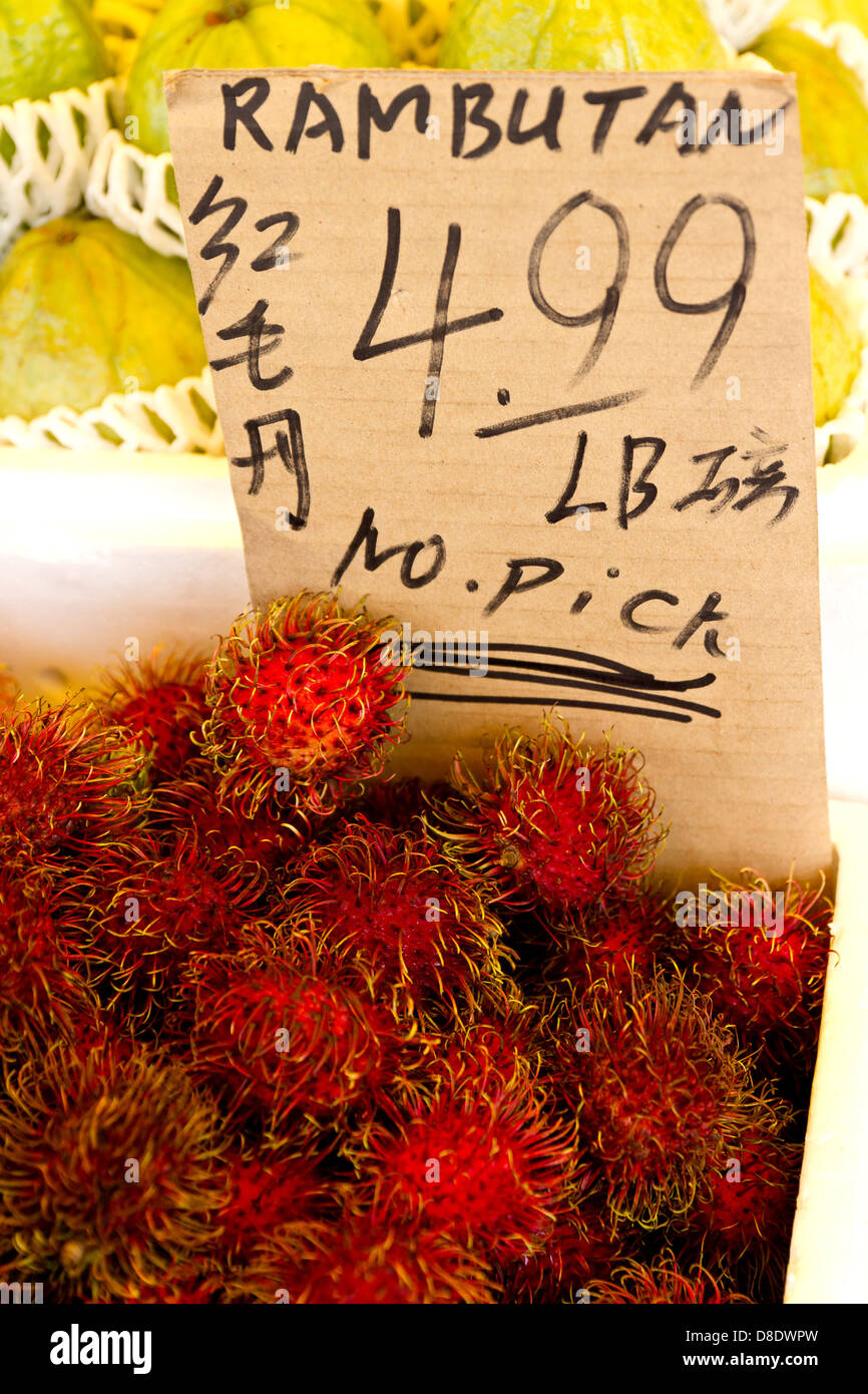 Basket of rambutan for sale at outdoor market in Toronto's Chinatown Stock Photo