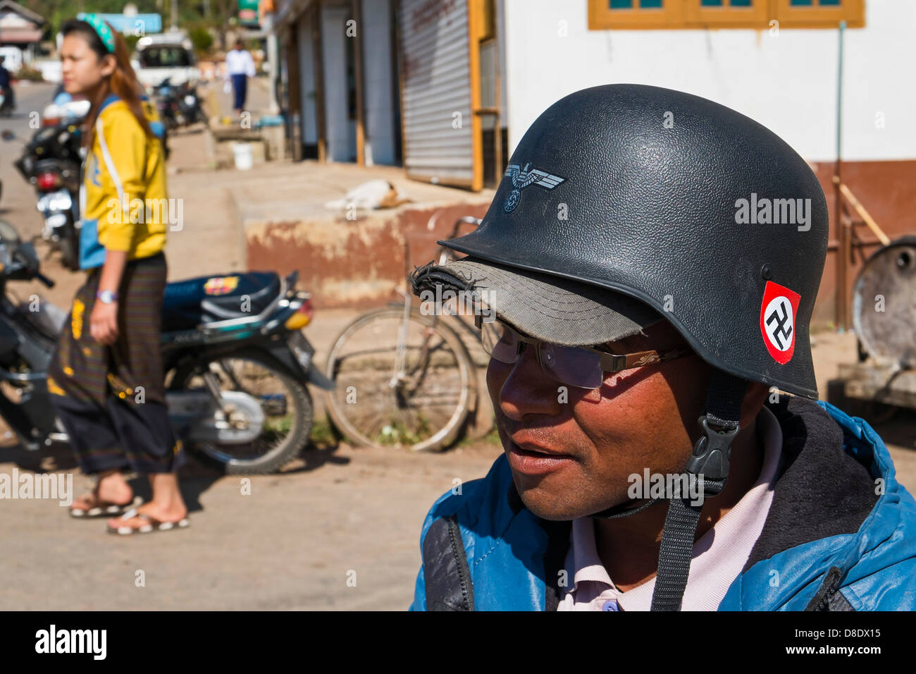 Biker wearing a helmet labeled with German Reichsadler and swastika, Kalaw, Myanmar Stock Photo