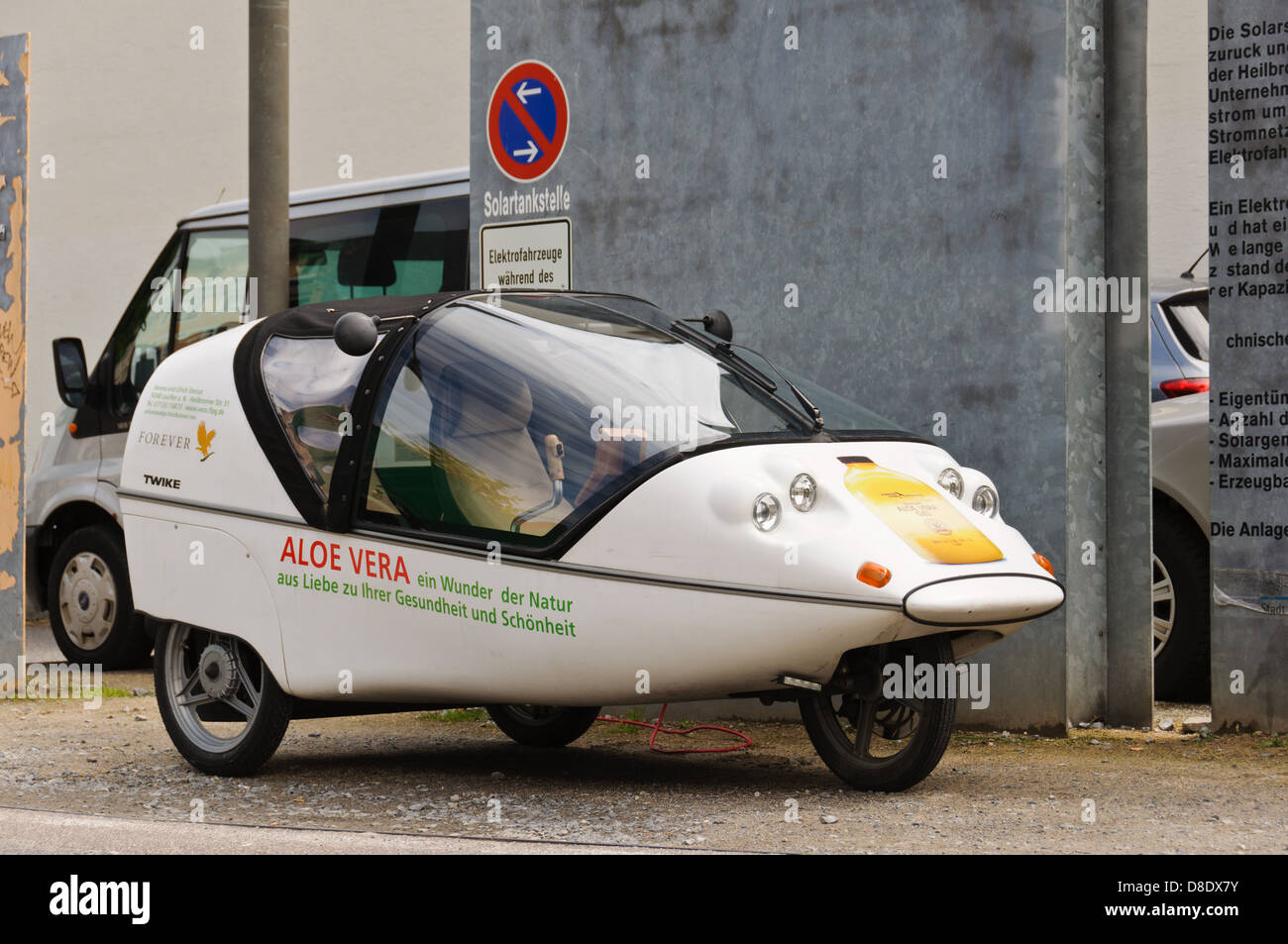 Ecofriendly electric car, trike, TWIKE TW 834, charging it´s batteries at a solar service station, Heilbronn Germany Stock Photo