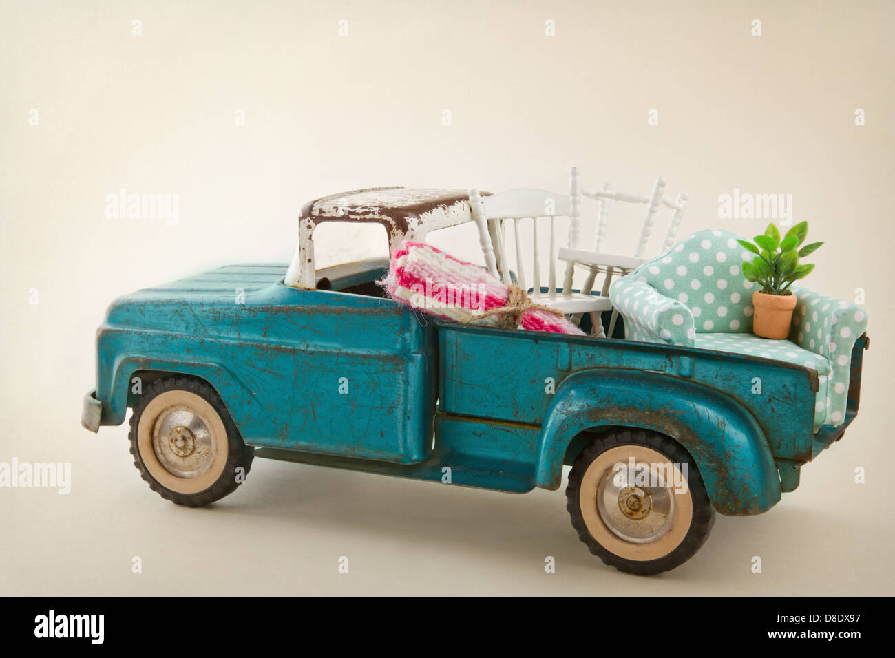 Old vintage toy truck packed with furniture - moving houses concept Stock Photo