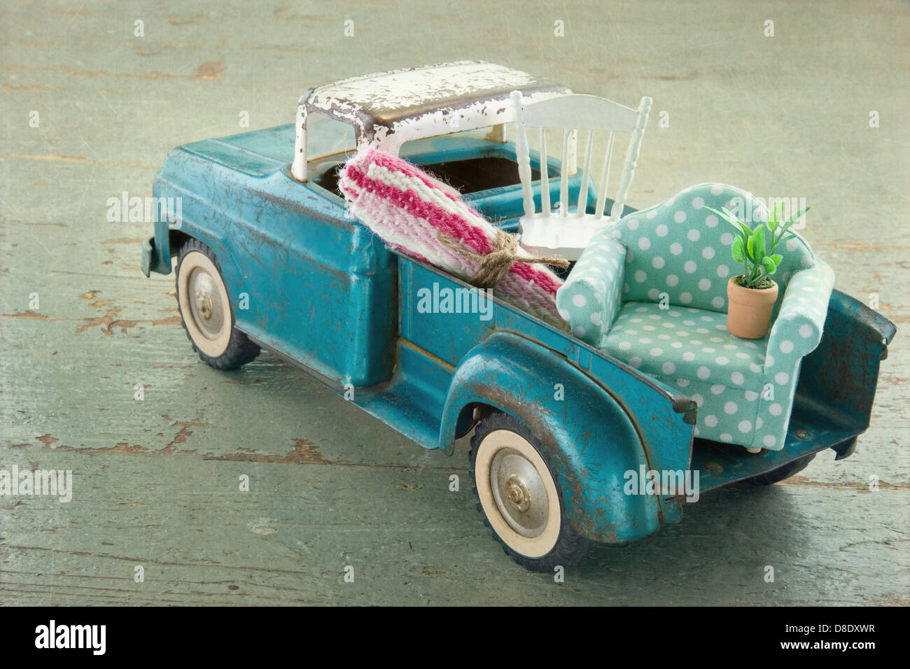 Old vintage toy truck packed with furniture - moving houses concept Stock Photo