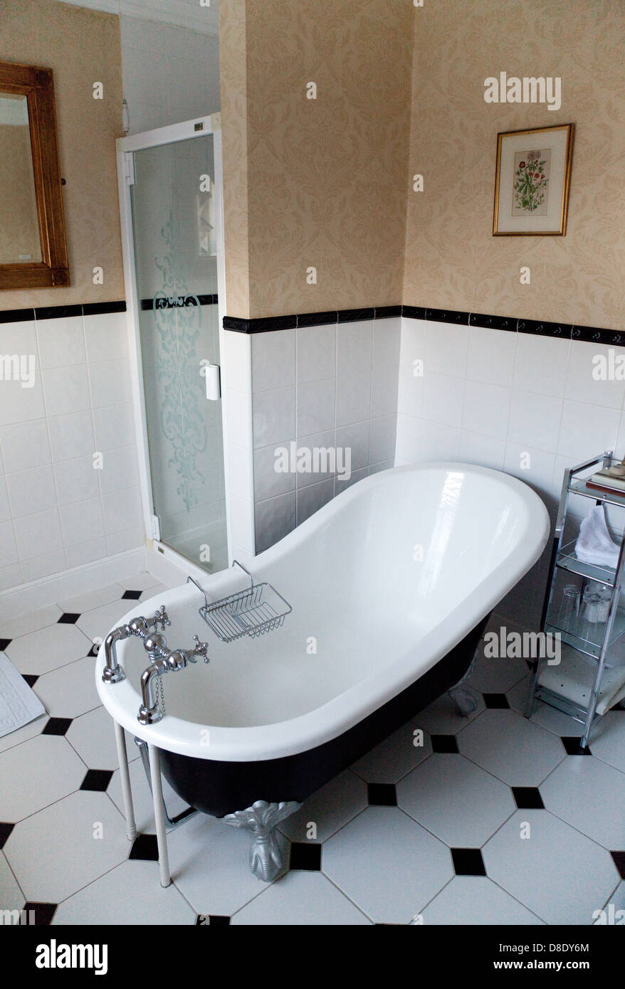 Traditional old iron bath in a hotel bathroom, the Beechwood Hotel, North Walsham, Norfolk UK Stock Photo