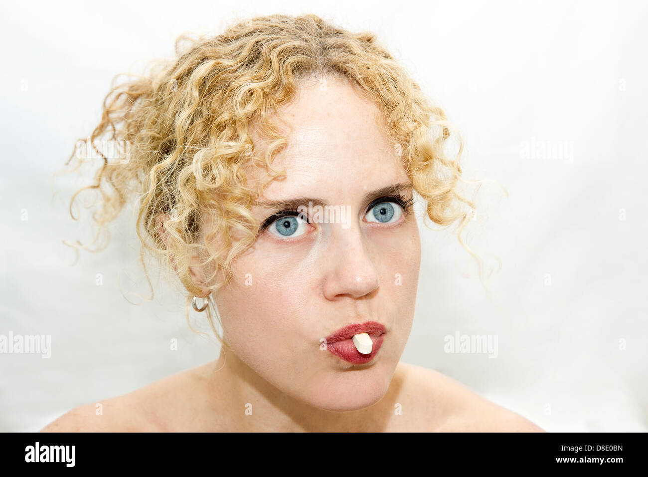 Women taking a pill Stock Photo