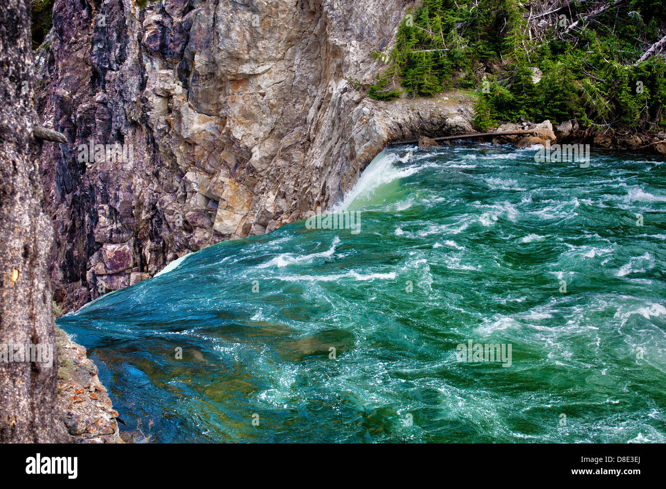 View of Yellowstone River pouring over brink of Lower Falls into Grand Canyon of Yellowstone at brink of falls Stock Photo