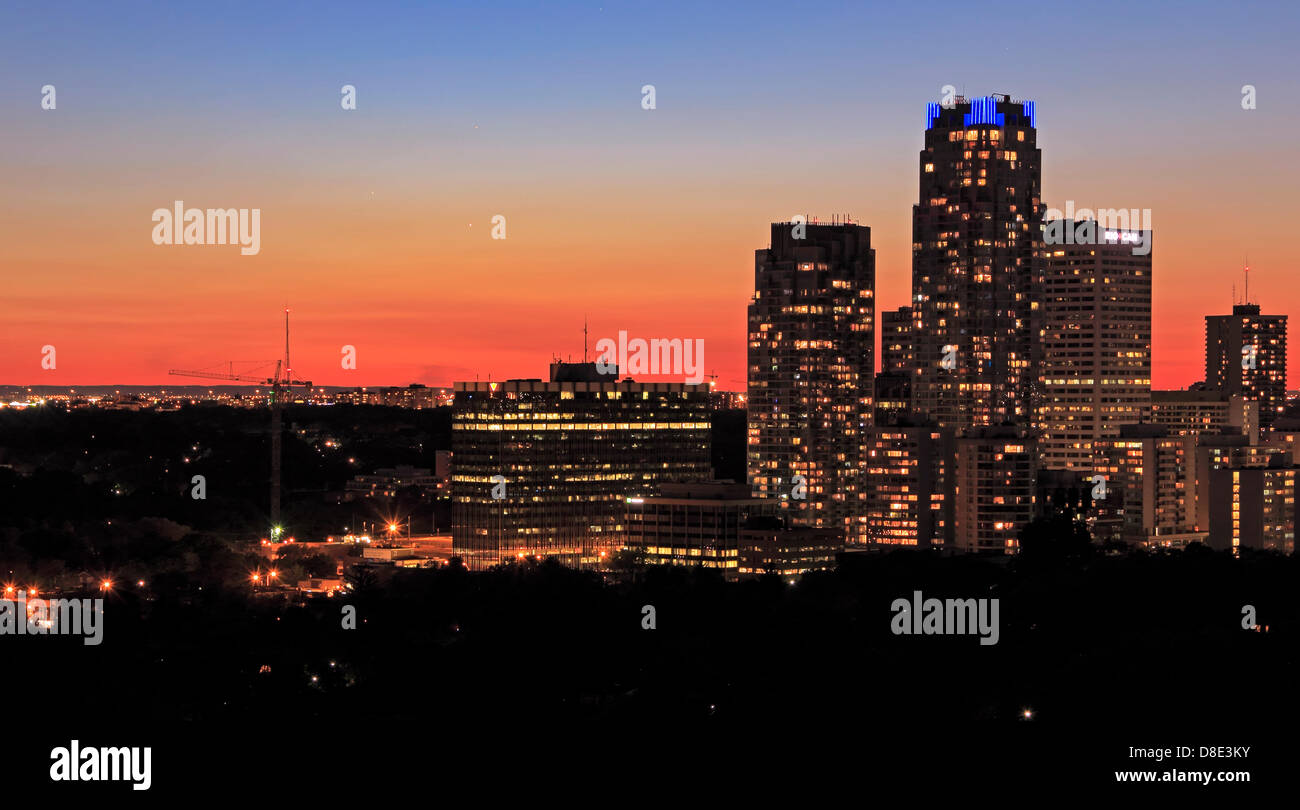 Venus, Jupiter and Mercury in perfect conjunction above buildings in Yonge and Eglinton area in western sky. Stock Photo