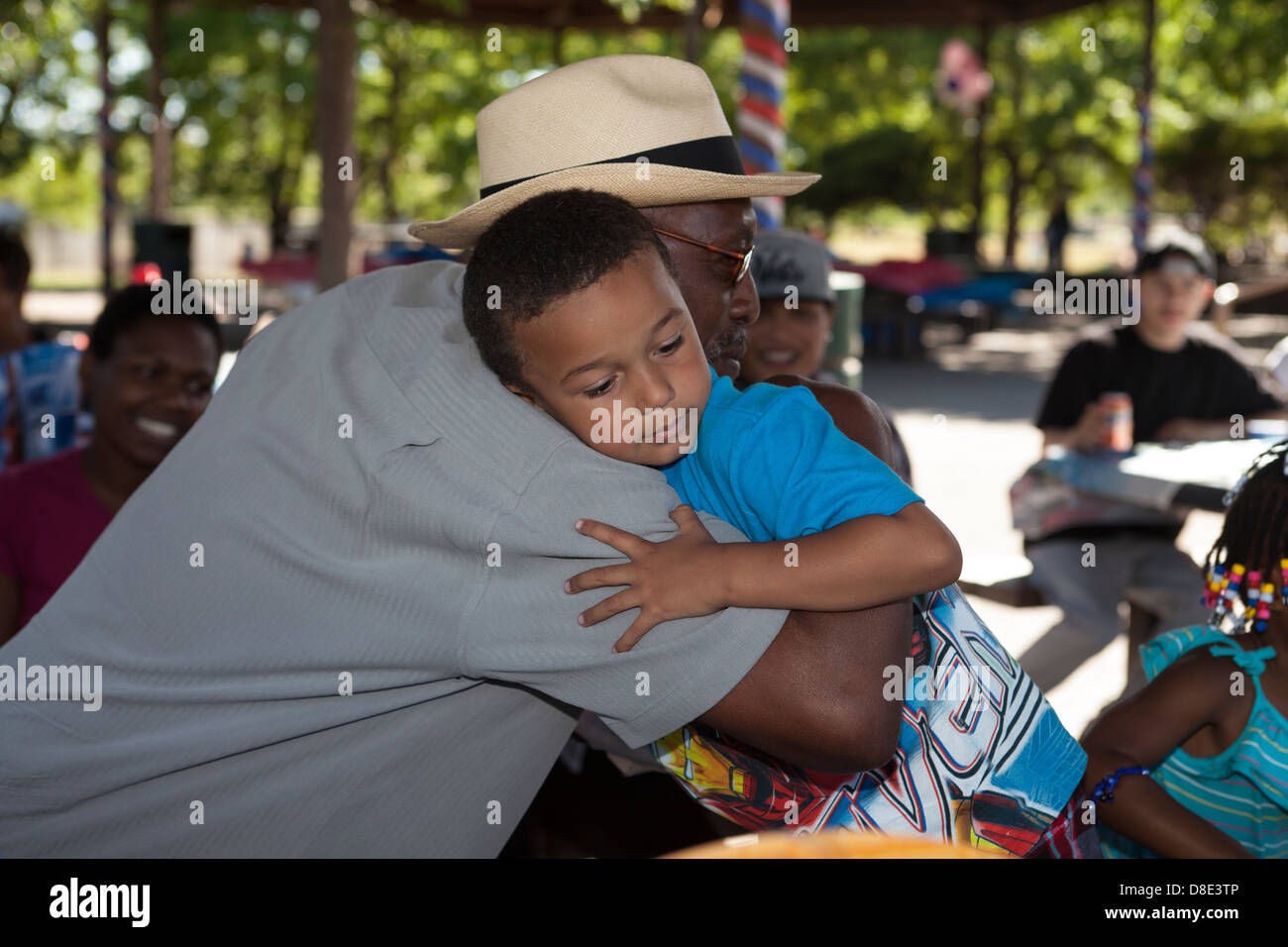 African American birthday boy hugging his great grandpa, Finley Park, Santa Rosa, California, USA, North America Stock Photo