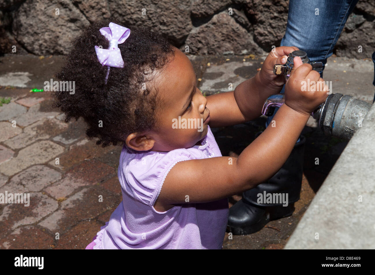 African American little toddler girl playing at Finley Park, Santa Rosa, California, USA Stock Photo