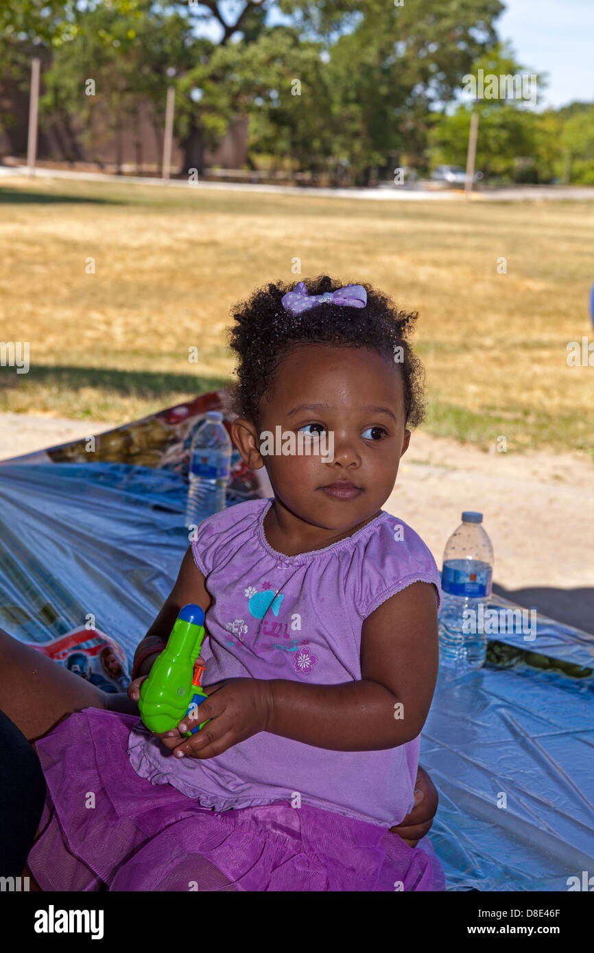 African American little toddler girl wearing pink dress, Santa Rosa, California, USA. Stock Photo