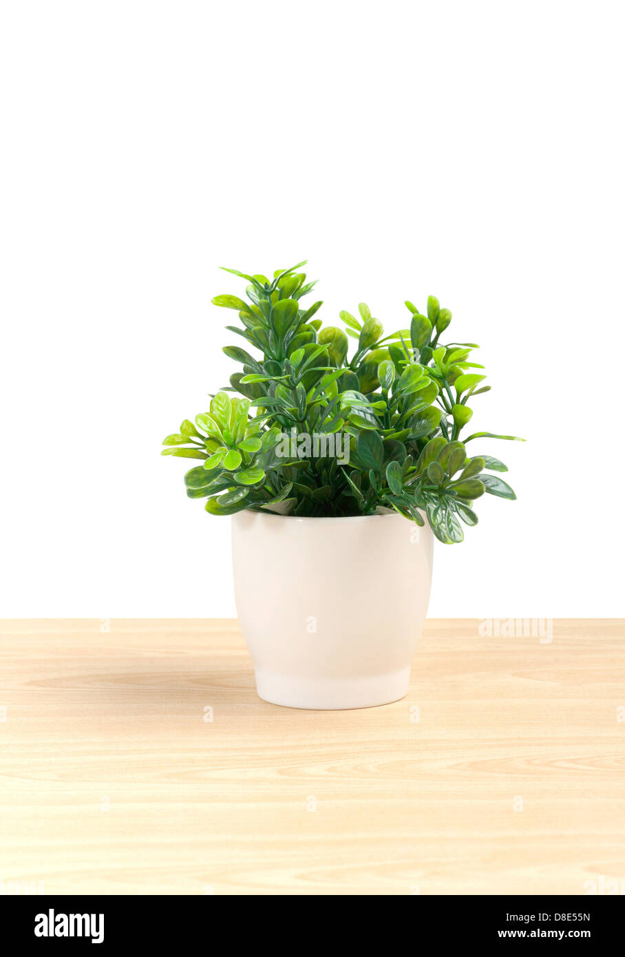 artificial leaf in small porcelain vase for home decoration Stock Photo
