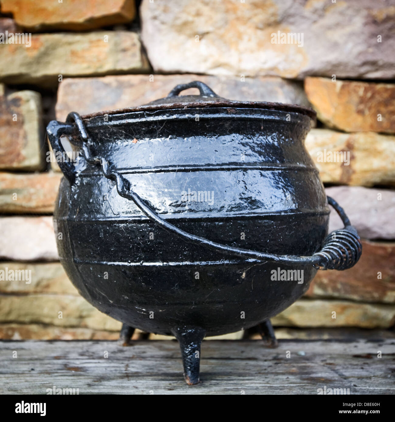 Black dutch oven, antique cooking pot, against brick wall Stock Photo -  Alamy