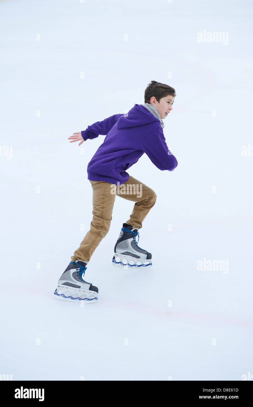 Boy ice-skating on a frozen lake Stock Photo