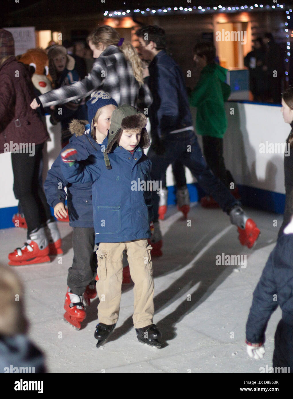 Two boys skate in Indian file on a dry skate rink in Framlingham