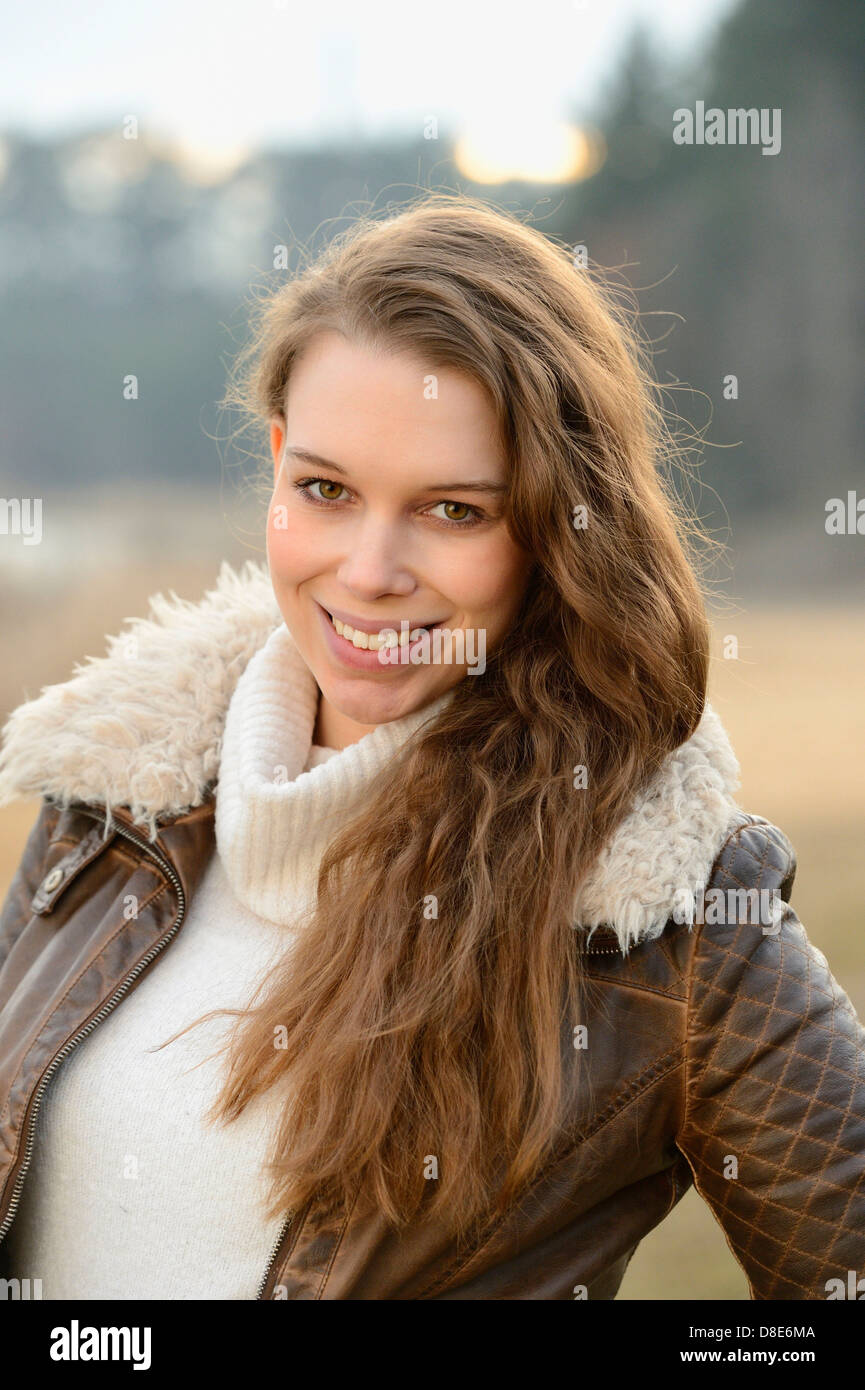 Smiling young woman outdoors, portrait Stock Photo