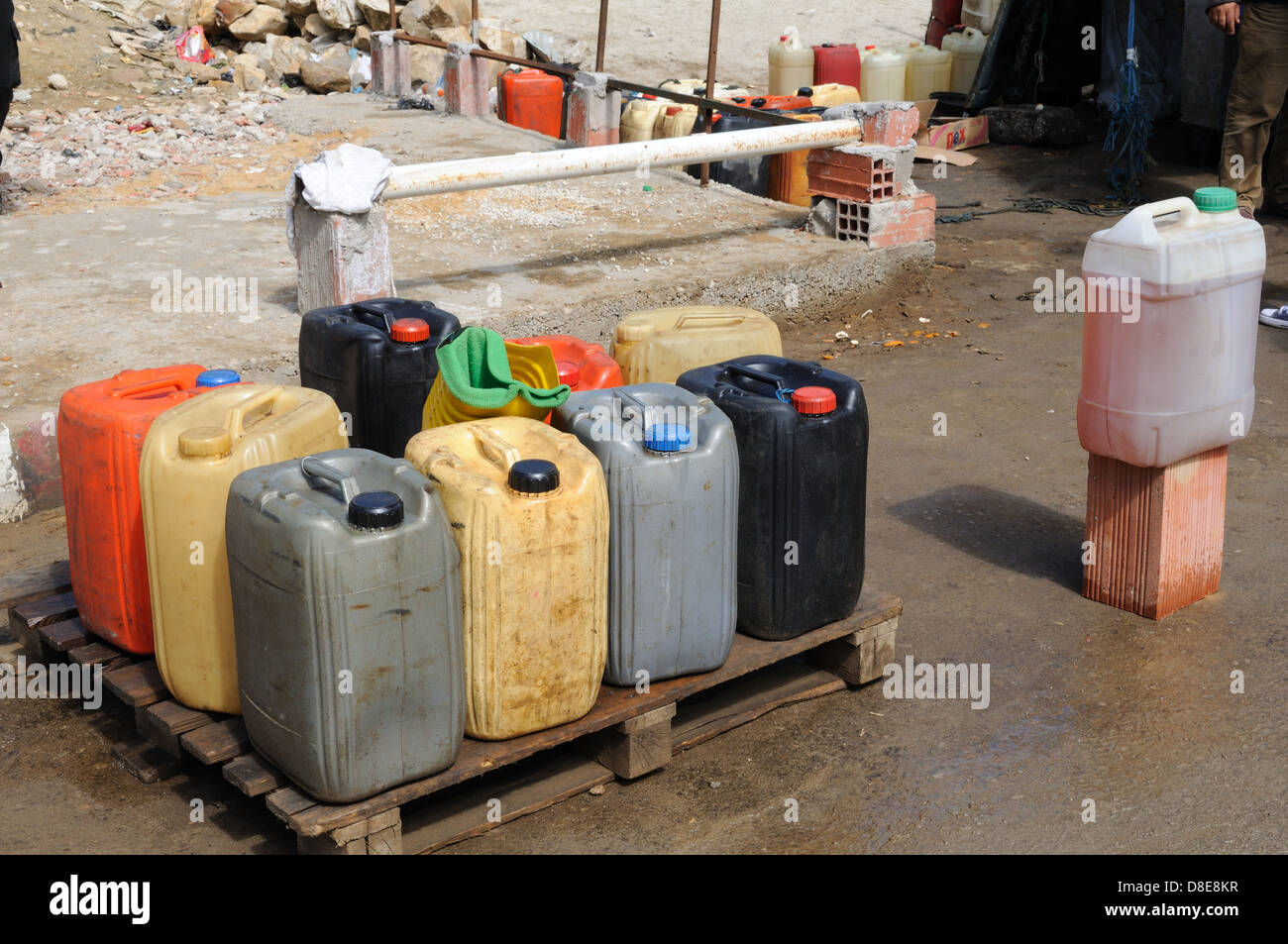 Petrol in plastic drums brought in illegally from Algeria and sold in Ain Draham market Tunisia Stock Photo
