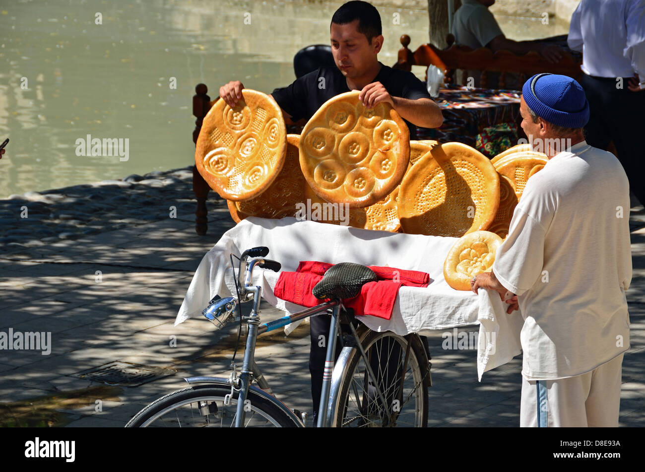 Man buying bread from a bread seller in Bukhara Stock Photo