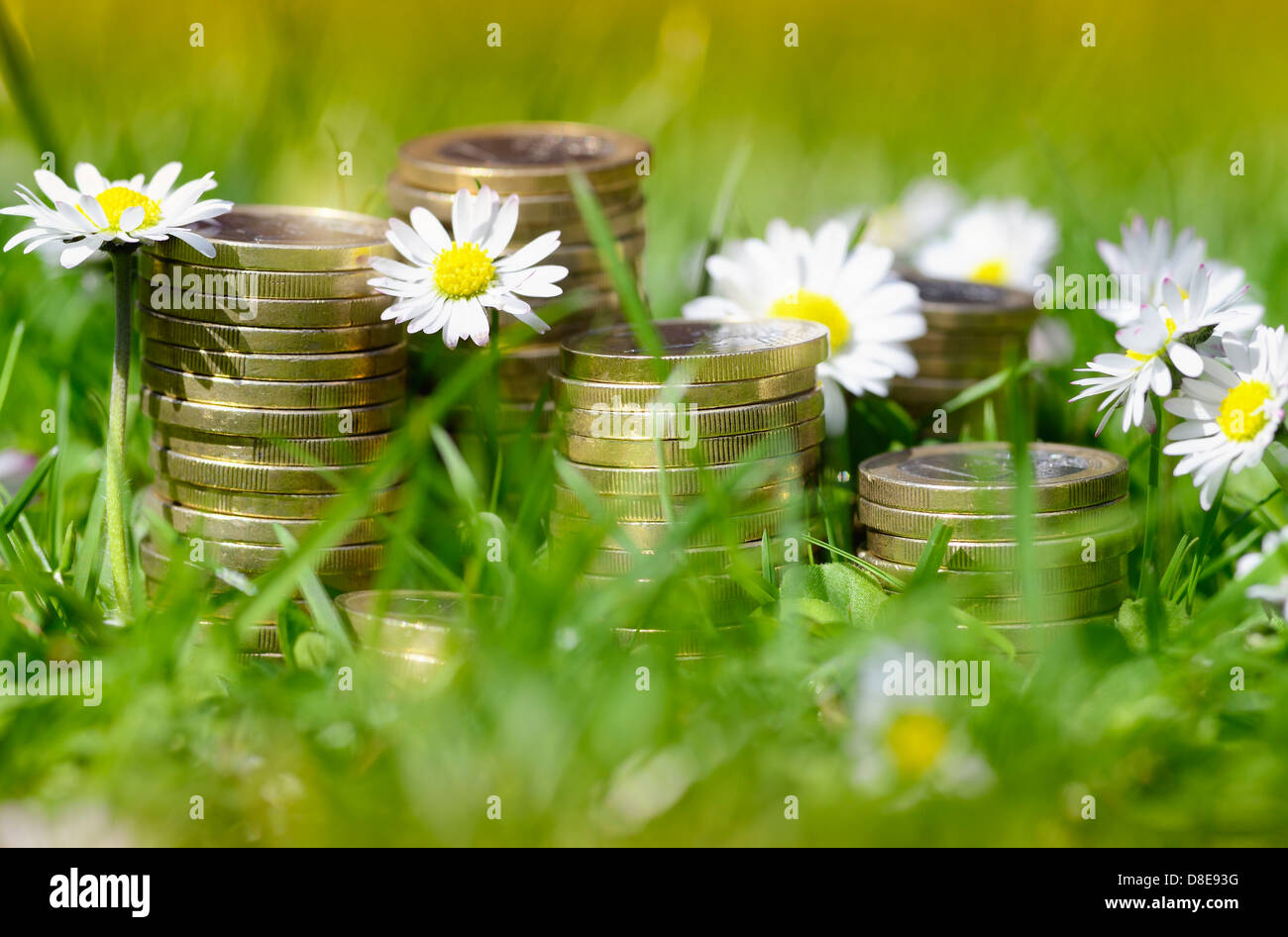 Piles of coins in the grass, investment Stock Photo