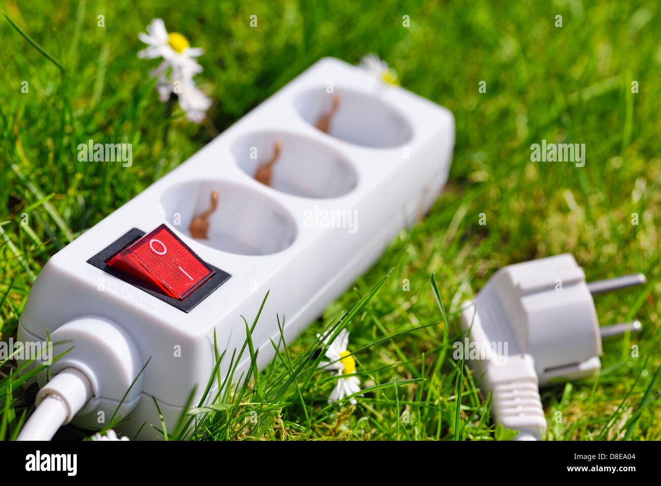 Outlet in grass, green energy symbol photo Stock Photo
