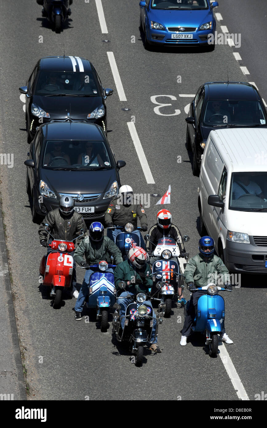 A group of mods on their scooters stuck in a traffic jam heading into Brighton on the A23 this morning as huge crowds were expected to hit the south coast for Bank Holiday Monday Stock Photo