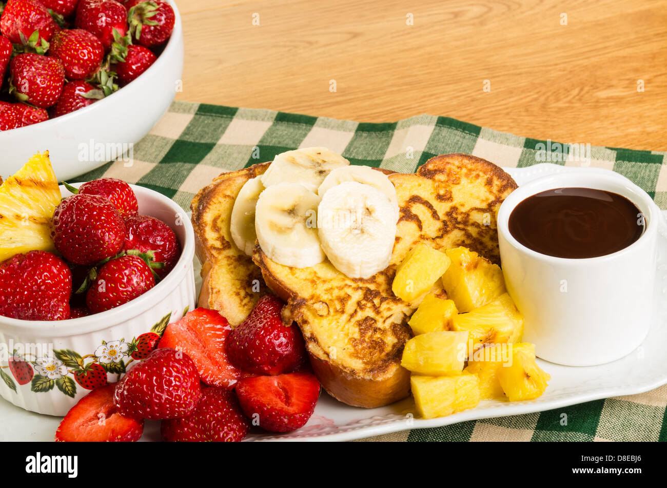 French toast with strawberries pineapple bananas and coffee Stock Photo Alamy