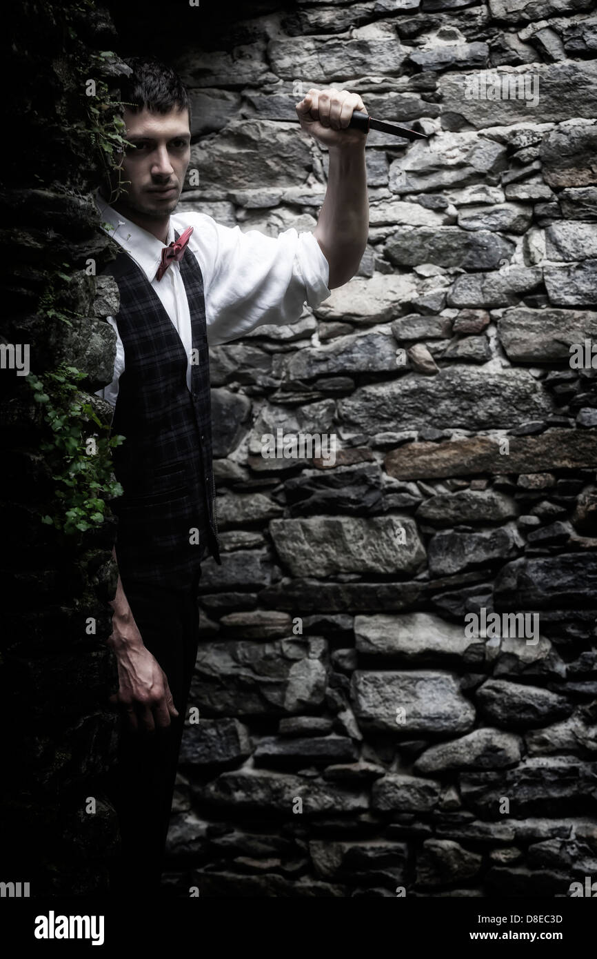a man in a dark alley with a knife Stock Photo Alamy