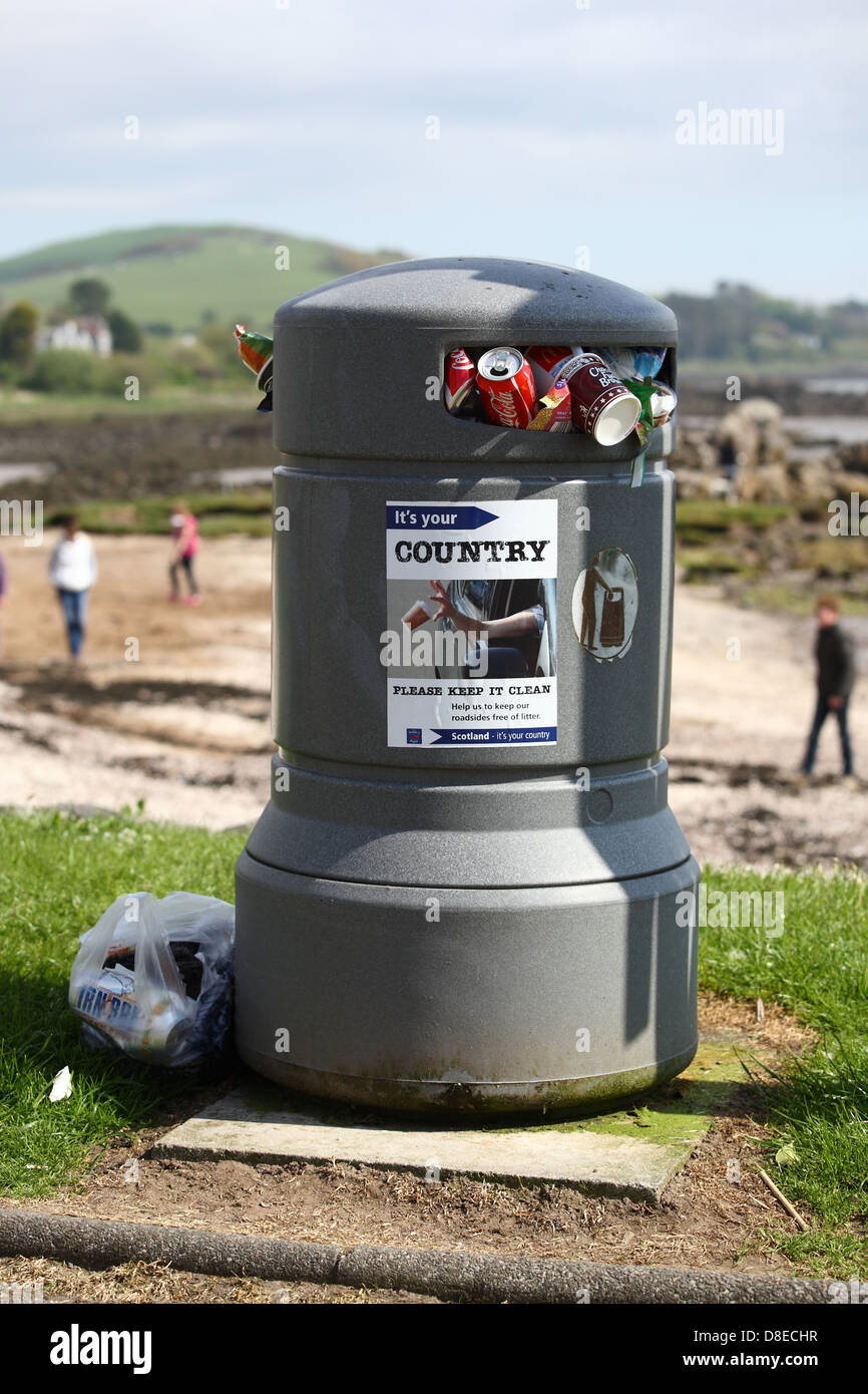 overflowing rubbish bin on scottish beach Stock Photo