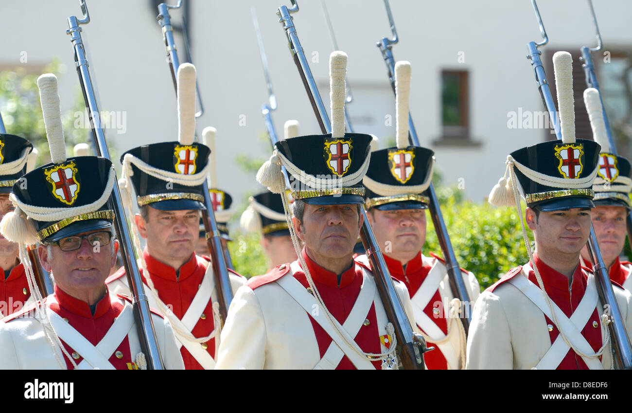 Reichenau, Germany, 27 May 2013. Members of the Reichenau militia attend a procession of the Holy Blood Festival in Reichenau, an island of the Bodensee lake, Germany, 27 May 2013. The relic, that is the centre of the procession, is said to contain blood-soaked soil of Golgatha, pieces of the cross of Jesus and a satin piece of cloth soaked with Christ's blood. The statue was brought to the island in the year 925. Photo: Patrick Seeger/DPA/Alamy Live News Stock Photo