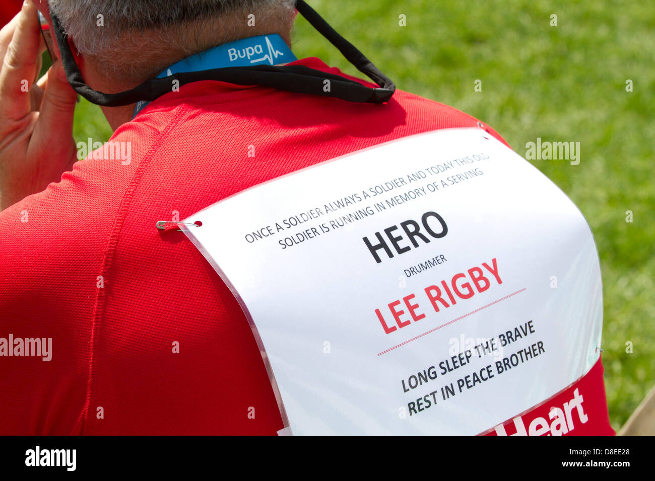 London, UK. 27th May 2013. A soldier runs in memory of drummer Lee Rigby who was murdered in Woolwich. Thousands of runners take part in the annual BUPA 10,000 road race through the streets of London with many runners running for various charities. Credit: amer ghazzal/Alamy Live News Stock Photo