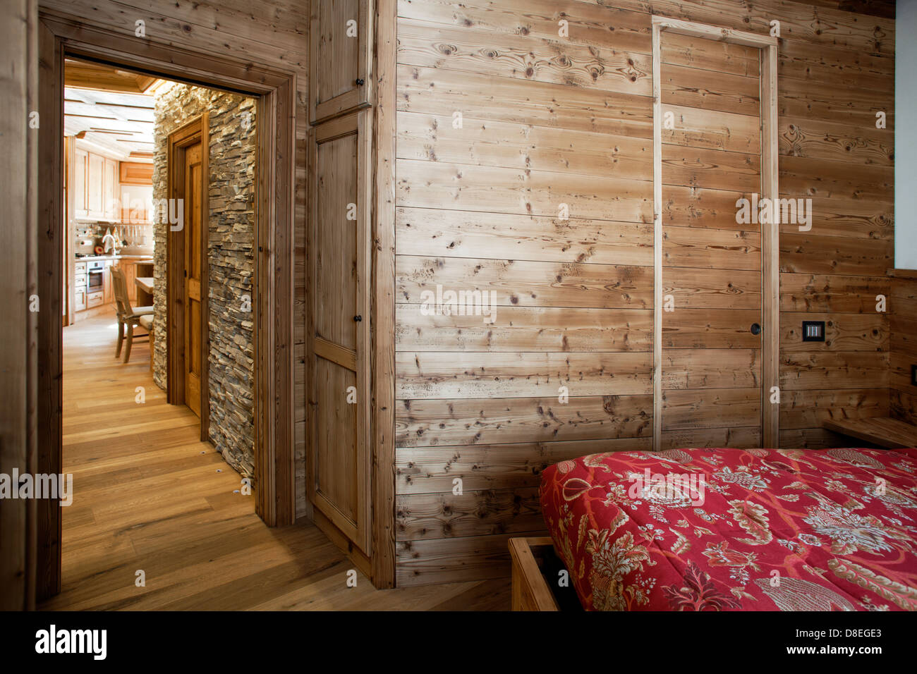 Alpine cottage interior with walls covered in traditional wood and stone Stock Photo