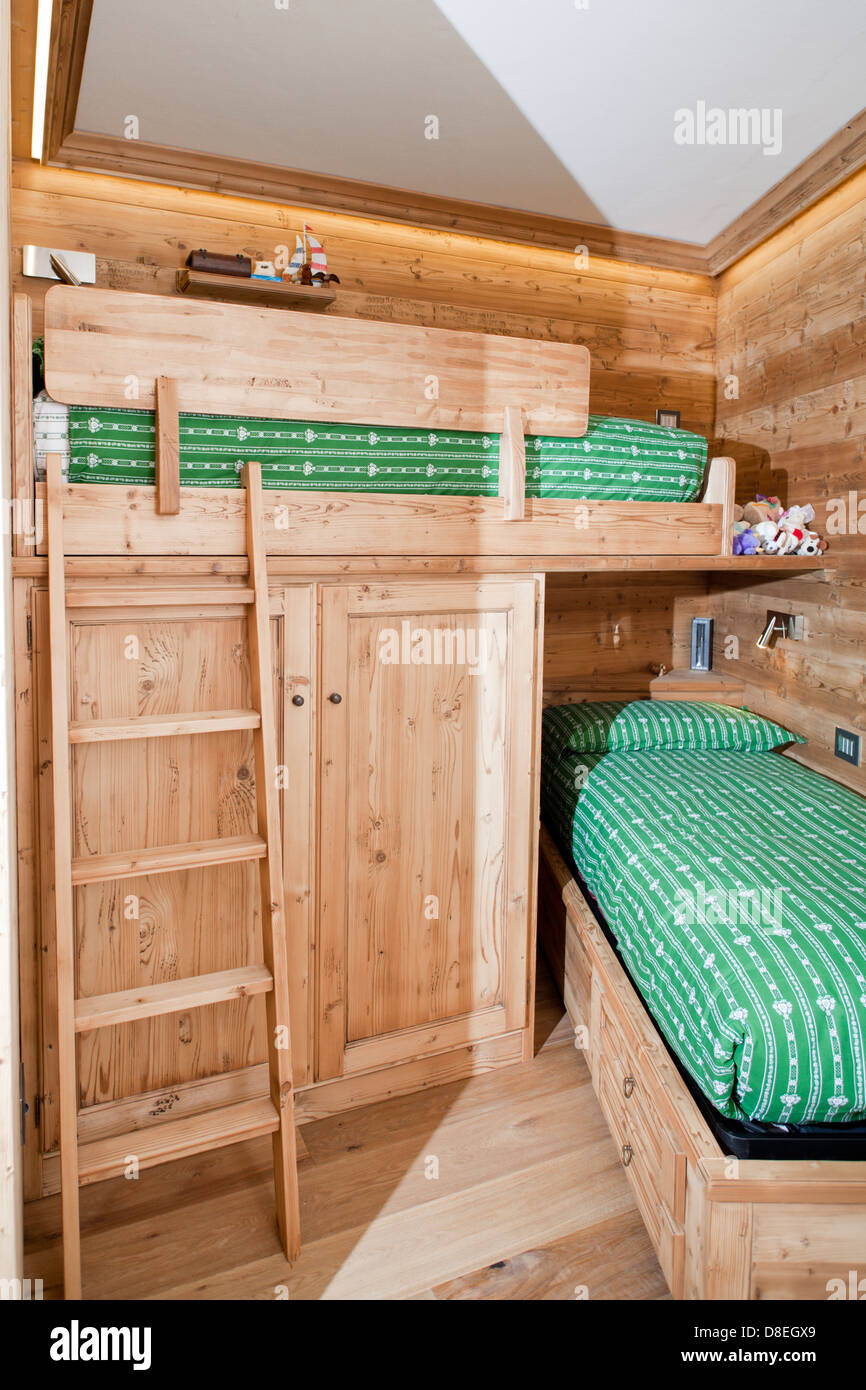 Tiny mountain cottage bedroom for kids in pine wood Stock Photo