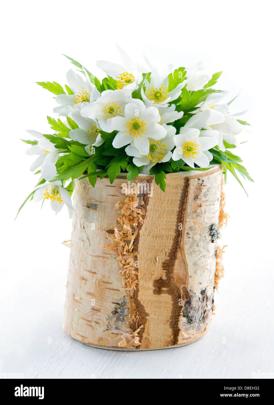 Bouquet of white spring flowers, wood anemones, in a rustic wooden