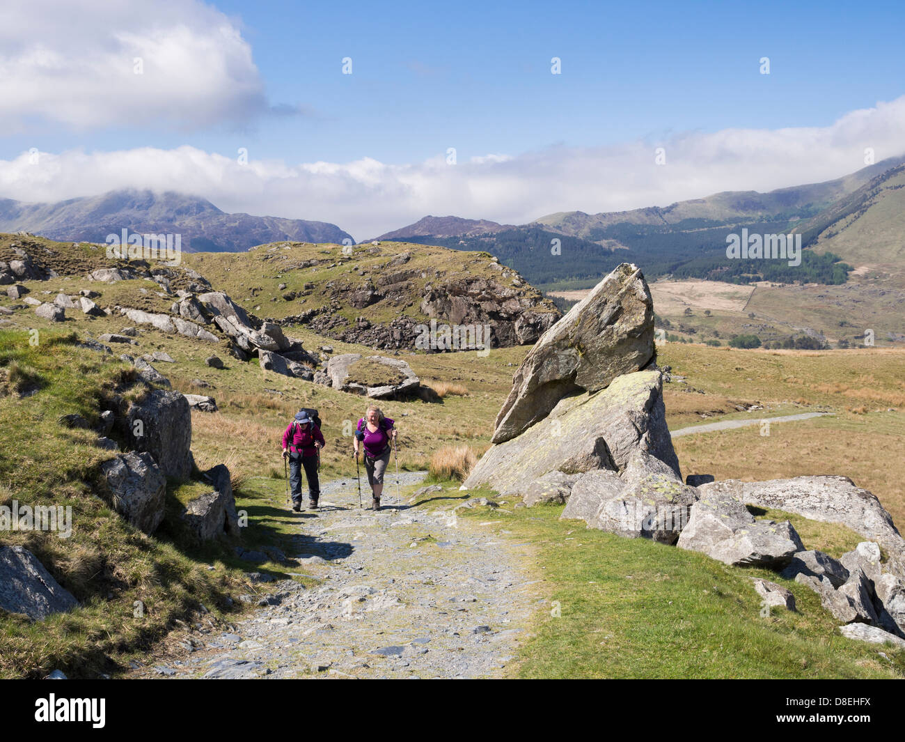 Hikers hiking on path from Rhyd Ddu up to Mount Snowdon in mountains of Snowdonia National Park (Eryri). Rhyd Ddu North Wales UK Britain Stock Photo
