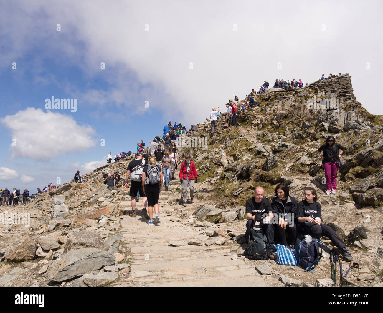 Scene on Snowdon summit crowded with tourists and walkers on a busy holiday weekend in summer. Snowdonia National Park Wales UK Stock Photo