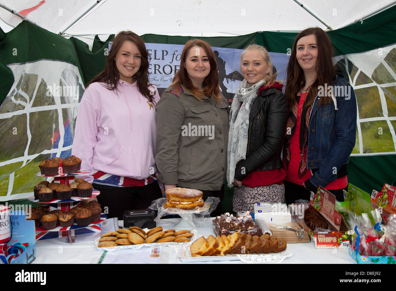 Turton, Lancashire, UK 27th May 2013. Help the Hero's Stall with Laura Carruthers 20, Liz Turner 20, Vicky Stewart 20, and Katie Pamphilan 21 from London at the annual traditional spring fair held in the grounds of the 600-year-old Turton Tower.  The event dates back more than 200 years, but went into decline in the early 20th century. It was revived in 2008 by the Friends of Turton Tower. Stock Photo