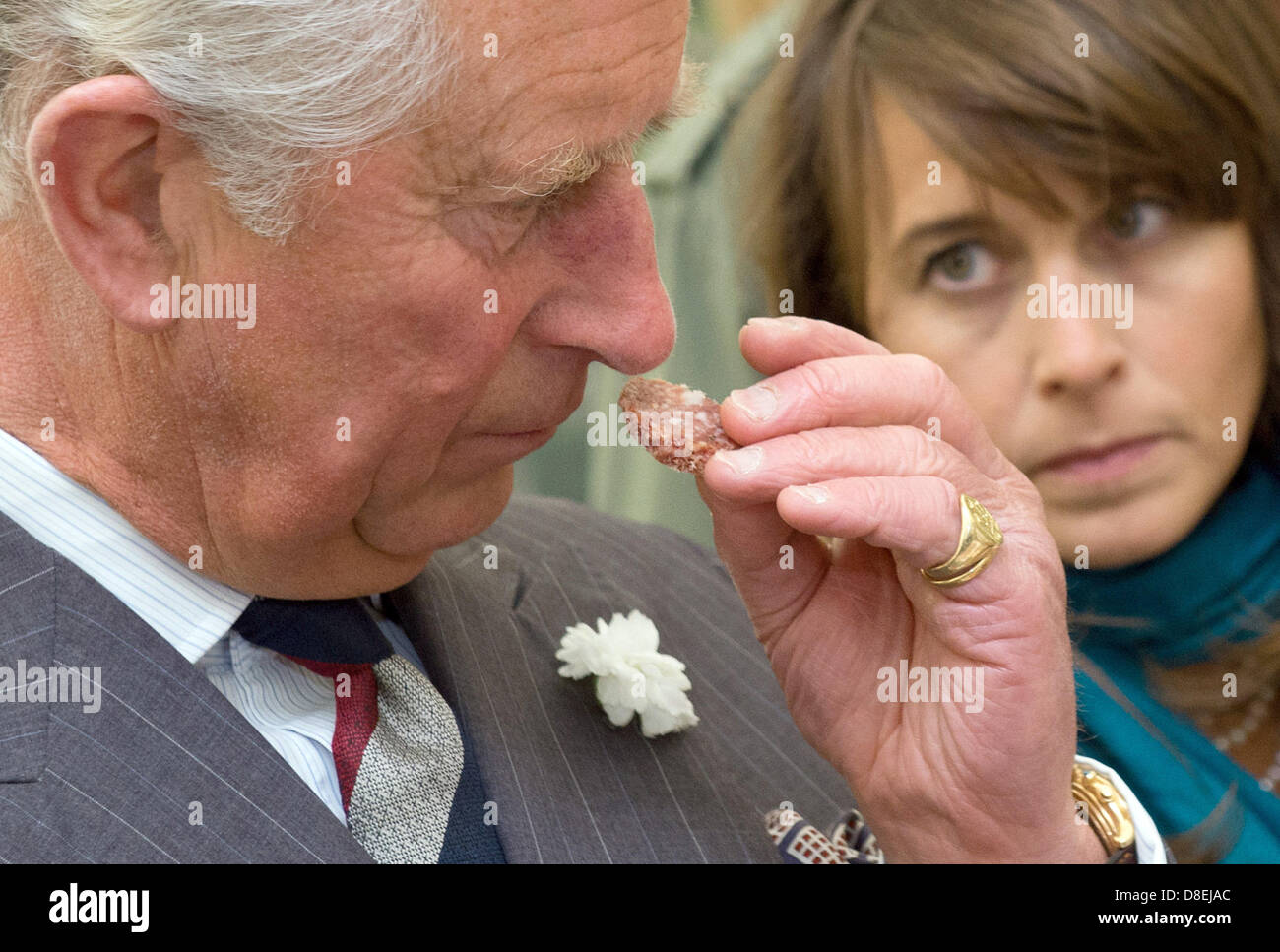 heir-to-the-english-throne-prince-charles-smells-a-slice-of-a-sausage-D8EJAC.jpg