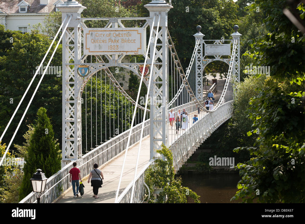 Walking a cross the Queens Park Suspension bridge over the River Dee in