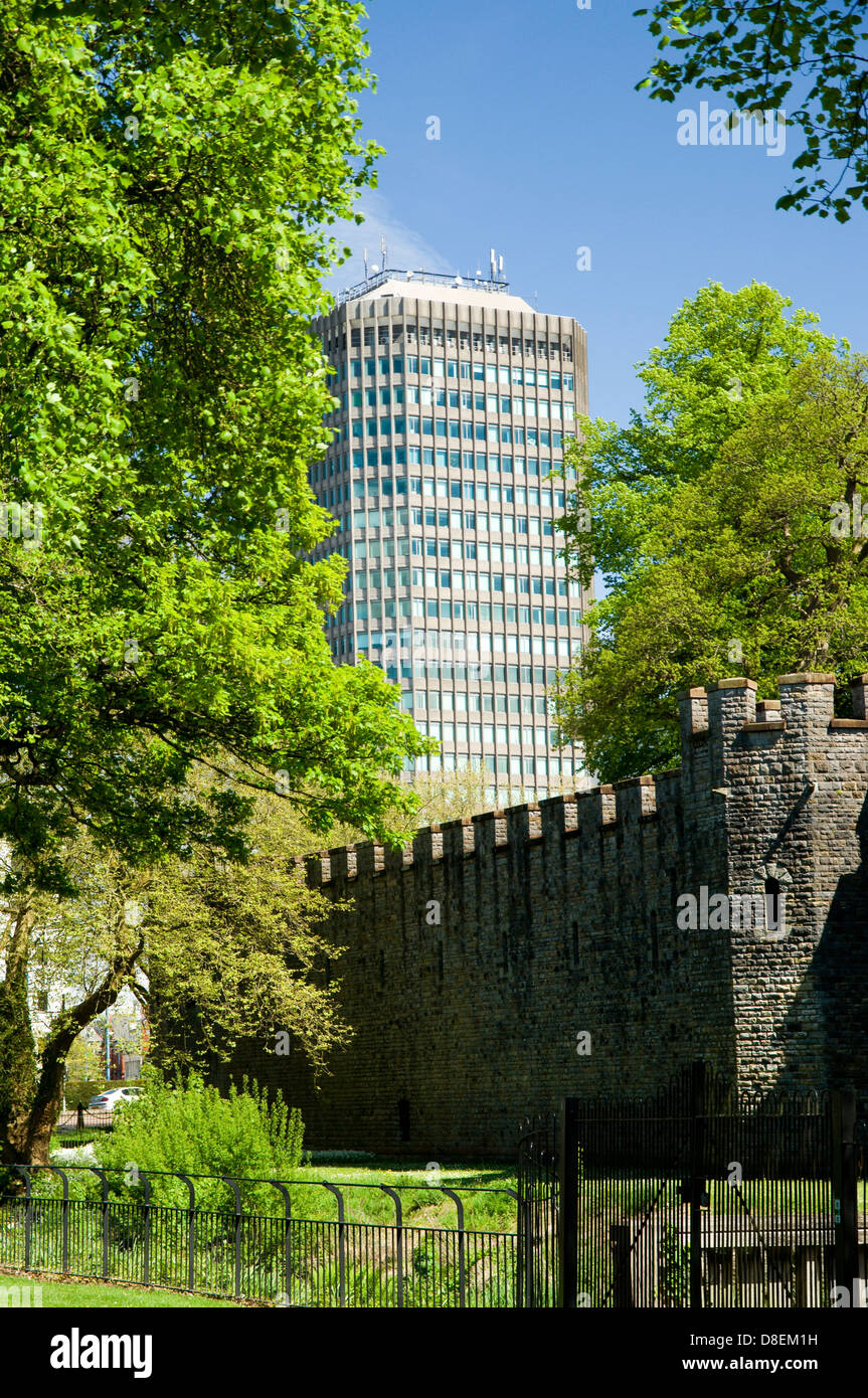 capital tower or the pearl assurance house towering over the castle walls from bute park, cardiff, wales. Stock Photo