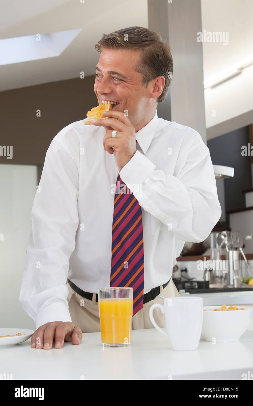 Man having breakfast before work Stock Photo